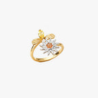 Justerbar fidgetring i guld med drejeligt solblomst-motiv og orange midte