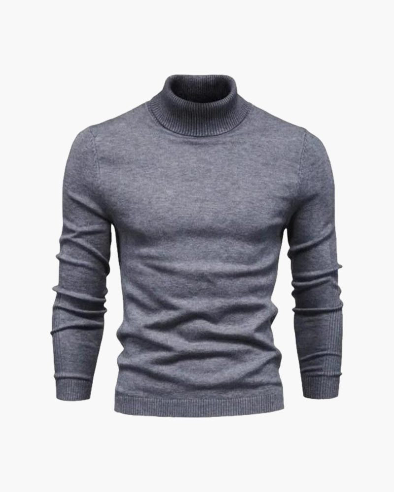 Grå rullekrave strikbluse med ribstrikkede manchetter og elastisk ribkant i bunden.